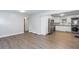 Open-concept living room with stainless steel kitchen appliances and a stackable washer/dryer at 2598 Elliott Nw St, Atlanta, GA 30318