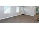 Bright living room featuring hardwood floors, white walls, and large windows providing ample natural light at 2598 Elliott Nw St, Atlanta, GA 30318