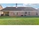 Brick home with a well-maintained lawn and covered patio at 359 Interlake Pass, Mcdonough, GA 30252