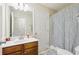 Well-lit bathroom with a single vanity and decorative shower curtain at 359 Interlake Pass, Mcdonough, GA 30252