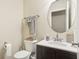 Neat half bath featuring a new vanity, circular mirror, and fresh design at 359 Interlake Pass, Mcdonough, GA 30252