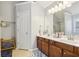 Bright bathroom with double sinks, stylish vanity, large mirror, and ample storage at 359 Interlake Pass, Mcdonough, GA 30252