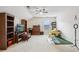Spacious bonus room with a ceiling fan, carpet flooring, and large window providing natural light at 359 Interlake Pass, Mcdonough, GA 30252