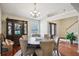 Inviting dining room showcasing hardwood floors and a decorative china cabinet at 359 Interlake Pass, Mcdonough, GA 30252