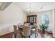 Cozy dining room features hardwood floors, wainscoting, and decorative chandelier at 359 Interlake Pass, Mcdonough, GA 30252