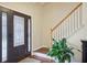 Elegant entryway with stained-glass door, hardwood floors, and white-railed staircase at 359 Interlake Pass, Mcdonough, GA 30252