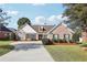 Charming single-story brick home featuring manicured landscaping and a concrete driveway at 359 Interlake Pass, Mcdonough, GA 30252