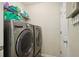 Modern laundry room with stainless steel washer and dryer units at 359 Interlake Pass, Mcdonough, GA 30252