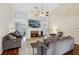Spacious living room features a brick fireplace and vaulted ceilings at 359 Interlake Pass, Mcdonough, GA 30252