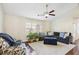 Inviting living room featuring a ceiling fan, stylish furniture, and abundant natural light at 359 Interlake Pass, Mcdonough, GA 30252