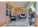 Cozy covered patio area with wicker furniture and grill at 359 Interlake Pass, Mcdonough, GA 30252