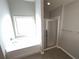 Bathroom features a shower, bathtub and window for natural light at 404 Providence Walk St, Canton, GA 30114