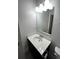 Bathroom features a vanity sink with a large mirror and modern lighting at 404 Providence Walk St, Canton, GA 30114