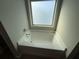 Bright bathroom featuring a tub with tiled window surround in a neutral color palette at 404 Providence Walk St, Canton, GA 30114