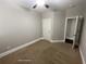 Neutral bedroom boasts carpet flooring and a door leading to other rooms at 404 Providence Walk St, Canton, GA 30114