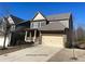 Charming two-story home featuring a brick facade, covered porch, and two-car garage at 404 Providence Walk St, Canton, GA 30114