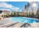 Community Pool surrounded by fencing, trees, and lounge chairs, with an adjacent clubhouse at 404 Providence Walk St, Canton, GA 30114