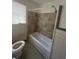 Bathroom featuring tiled walls and floors, and a bathtub at 2319 Browns Mill Se Rd, Atlanta, GA 30315