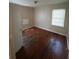 Bedroom featuring gleaming hardwood floors and a bright window, offering a cozy space at 2319 Browns Mill Se Rd, Atlanta, GA 30315