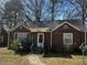 Charming brick home featuring a well-maintained front yard with trees at 2319 Browns Mill Se Rd, Atlanta, GA 30315