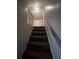 Carpeted staircase leading to an upper level with natural light at 2319 Browns Mill Se Rd, Atlanta, GA 30315