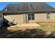 The backyard features a small patio area and mature landscaping at 6682 Biscayne Blvd, Rex, GA 30273