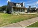 Charming one-story home with a front porch, green trim, and a well-maintained lawn at 6682 Biscayne Blvd, Rex, GA 30273