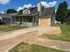 A one-story home featuring a covered porch, a driveway, and an attached garage at 6682 Biscayne Blvd, Rex, GA 30273