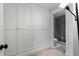 Bathroom with large linen closet and glass shower doors with marble tile surround at 189 Westminster Dr, Atlanta, GA 30309