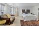 Bright bedroom with a large decorative rug, a sofa, and large windows, creating a warm and inviting space at 189 Westminster Dr, Atlanta, GA 30309