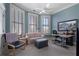 Comfortable bedroom featuring large windows, a ceiling fan, and versatile seating, creating a relaxing and functional space at 189 Westminster Dr, Atlanta, GA 30309