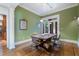 Dining room featuring hardwood floors, a large dining table, modern lighting, and natural light at 189 Westminster Dr, Atlanta, GA 30309