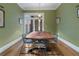 Dining room with hardwood floors, large table, modern pendant lights, and access to outdoor space at 189 Westminster Dr, Atlanta, GA 30309