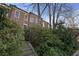 Brick home on a tree-lined street with mature landscaping and stone staircase to entry at 189 Westminster Dr, Atlanta, GA 30309