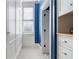 Bright hallway featuring custom white built-in cabinets and drawers, enhanced by a window and elegant blue accent wall at 189 Westminster Dr, Atlanta, GA 30309