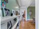 Hallway with built-in shelving, artwork, and hardwood floors, connecting to other rooms at 189 Westminster Dr, Atlanta, GA 30309