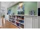 Hallway with built-in bookshelves, artwork, and hardwood floors, leading into the living area at 189 Westminster Dr, Atlanta, GA 30309