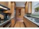 Galley kitchen featuring stainless steel refrigerator, built in pantry and cook top at 189 Westminster Dr, Atlanta, GA 30309