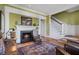 Cozy living room features a fireplace, hardwood floors, and a staircase to the upper level at 189 Westminster Dr, Atlanta, GA 30309