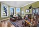 Bright living room featuring hardwood floors, large windows with stylish shutters, and comfortable seating at 189 Westminster Dr, Atlanta, GA 30309