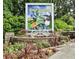 Atlanta Botanical Garden's 'Alice In Wonderland Reimagined' exhibit is advertised on a sign surrounded by colorful flowers at 189 Westminster Dr, Atlanta, GA 30309