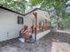 A quaint back porch featuring painted brick, stained posts, and a charming wooden railing at 221 Wonewok Dr, Canton, GA 30114