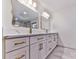 Modern bathroom featuring double vanity with marble countertop, gold fixtures and modern lighting at 221 Wonewok Dr, Canton, GA 30114