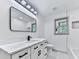 Bathroom with modern vanity, matte black faucet, stylish lighting, large mirror, and tile flooring at 221 Wonewok Dr, Canton, GA 30114