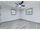 Bedroom featuring hardwood floors, ceiling fan and two windows at 221 Wonewok Dr, Canton, GA 30114