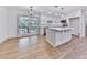 A white kitchen island with stainless steel appliances in a dining space with sliding glass doors at 221 Wonewok Dr, Canton, GA 30114