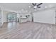 Open-concept living room with hardwood floors, a ceiling fan, and a view into the modern kitchen at 221 Wonewok Dr, Canton, GA 30114