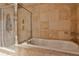 Elegant bathroom featuring a soaking tub and glass-enclosed shower with natural stone accents at 3180 Mathieson Ne Dr # 806, Atlanta, GA 30305