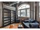 Comfortable seating area with city views, exposed brick, open shelving, and a modern reading lamp at 3180 Mathieson Ne Dr # 806, Atlanta, GA 30305