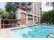 Beautiful outdoor pool with lounge chairs and bar area, set against a backdrop of a stylish brick building at 3180 Mathieson Ne Dr # 806, Atlanta, GA 30305